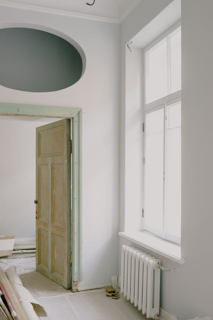 about-01 Contemporary apartment interior with shiny window and door near construction materials on floor in daytime